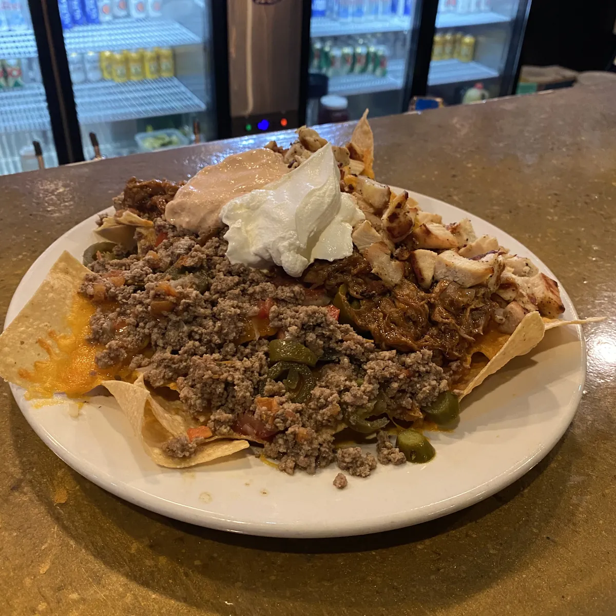 Loaded nachos on the bar at Nirvana DTX.