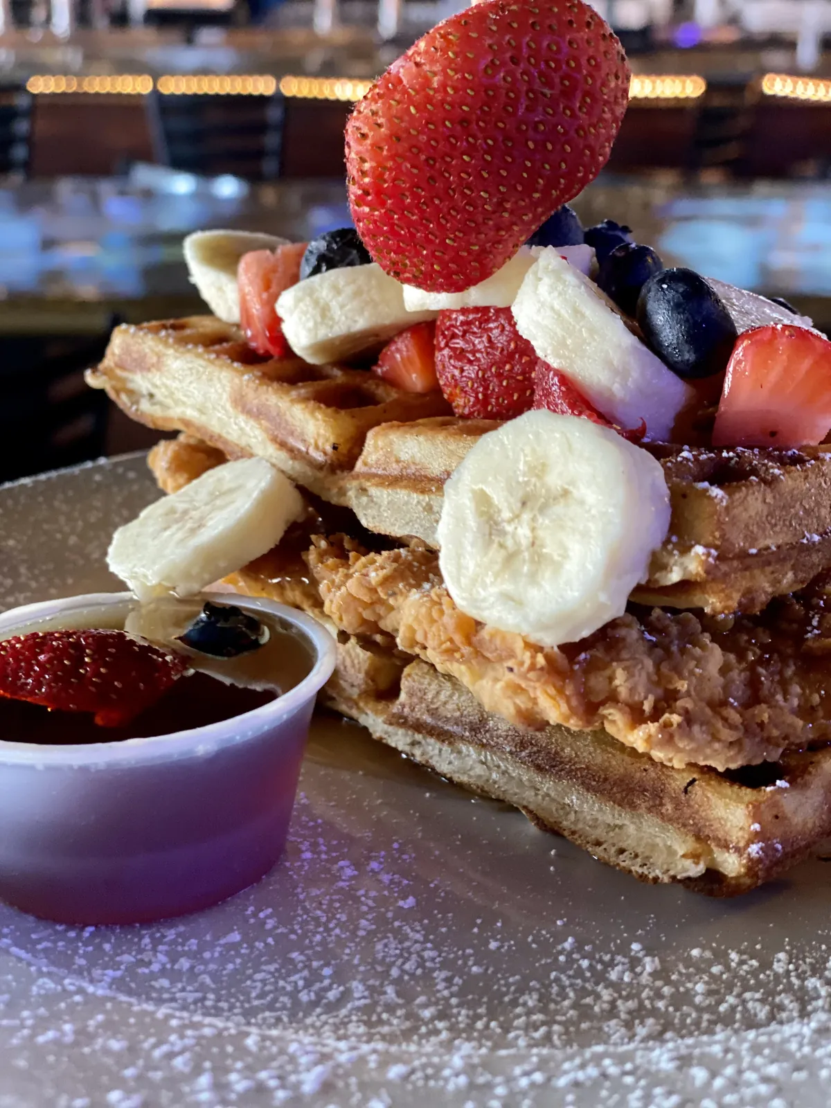 Chicken and waffles with fresh berries and banana at Nirvana DTX.