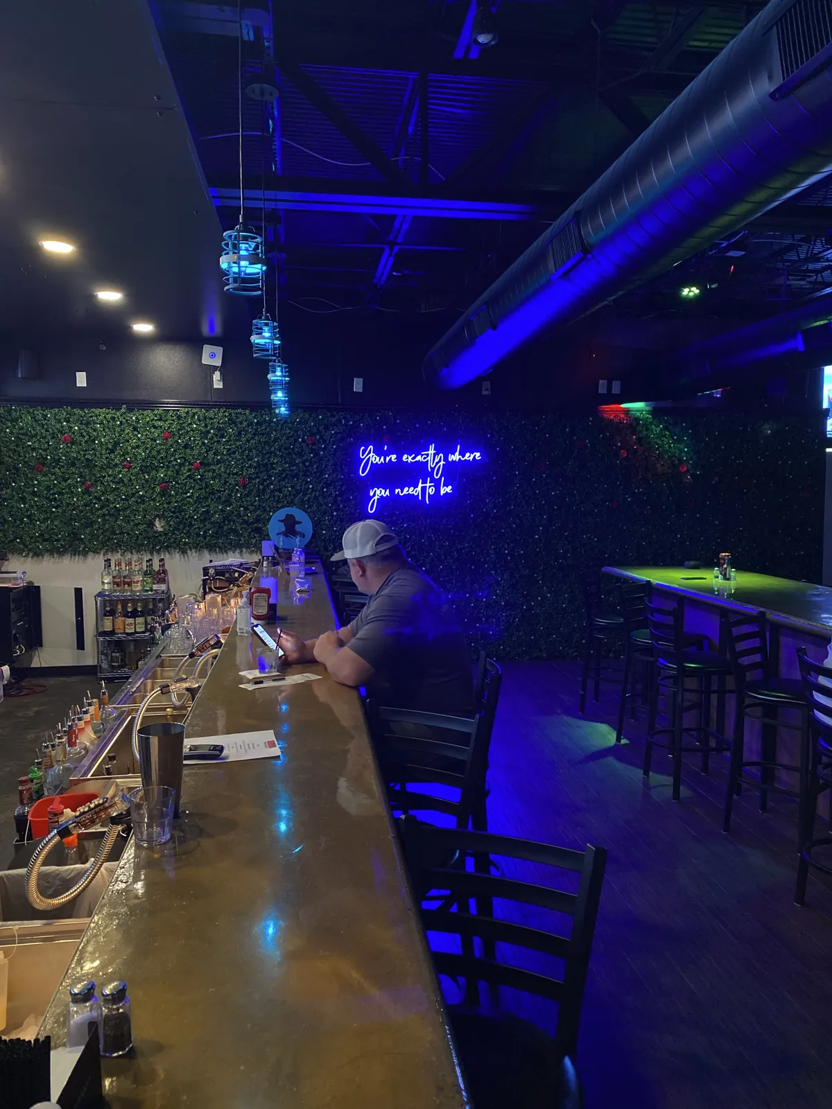 The Nirvana DTX bar and booths under blue light.