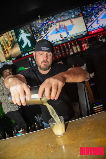 A Nirvana DTX bartender pouring a drink.