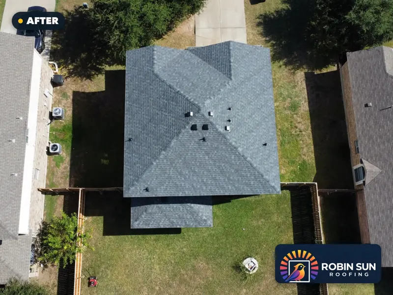 Drone view straight down on the same house with a new slate-gray roof.